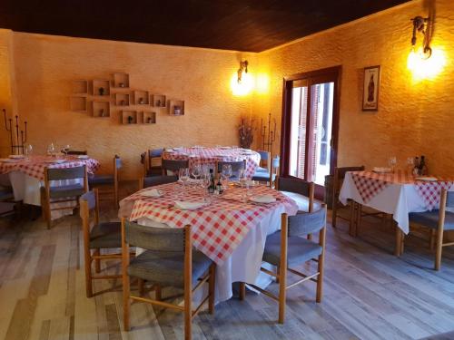 a dining room with tables and chairs in a room at Devesa Gardens in El Saler
