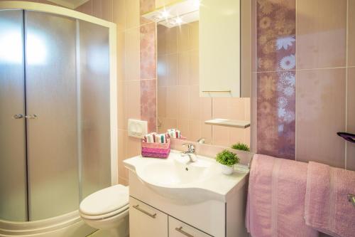 a bathroom with a sink and a toilet and a shower at Apartments Stasic in Vrbnik