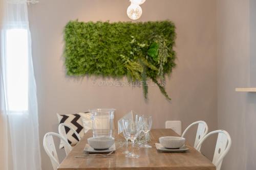 a dining room table with chairs and a green wall at Condominium Palace Resort Chatan II in Chatan