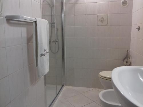 a bathroom with a shower and a toilet and a sink at Casa Luigi Sergio - affitto breve in Santo Stefano di Camastra