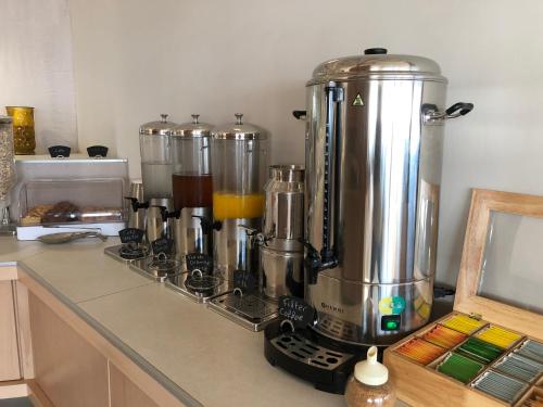 a kitchen counter with a blender on a counter top at Kavos Hotel & Suites in Stavros