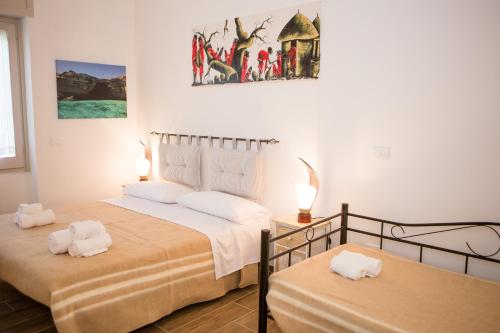 a bedroom with two beds with white towels on them at B&B Medali in Vernole