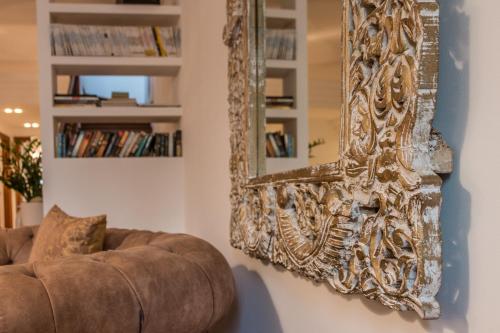 a mirror hanging on a wall next to a couch at La Loggia Al Duomo - Treviso in Treviso