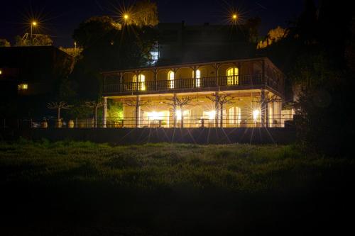a house lit up at night with lights at Le Clos des Sept Palmiers in Cavalaire-sur-Mer