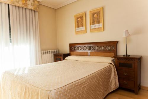 A bed or beds in a room at Apartamentos Tres Luces