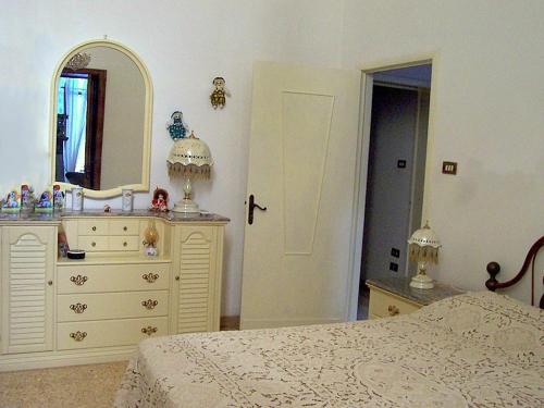 a bedroom with a white dresser and a mirror at B&B IreneMarchese Gluten Free in Taviano