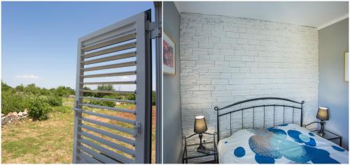 a bedroom with a bed and a balcony with a door at House Mellifera in Razvođe