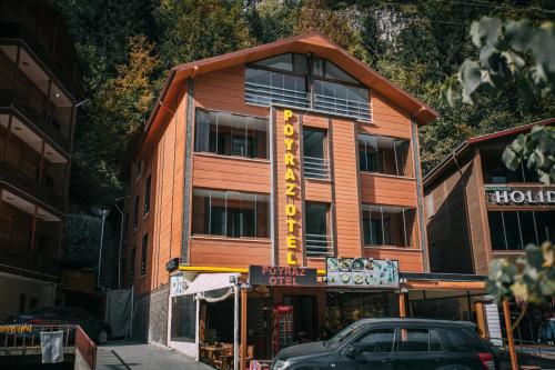 a building with a car parked in front of it at Poyraz Hotel Uzungöl in Uzungöl