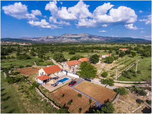 an aerial view of a house with a yard at House Mellifera in Razvođe