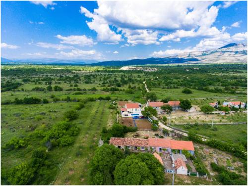 an aerial view of a farm with houses in a field at House Mellifera in Razvođe