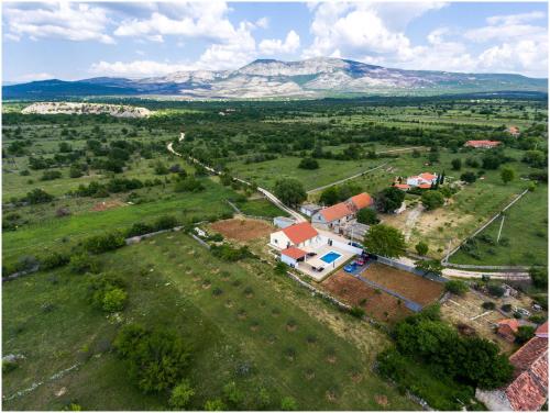 an aerial view of a house in a field at House Mellifera in Razvođe