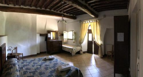 a bedroom with a bed and a dresser and a window at Fattoria Il Santo in Santo