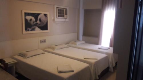 Llit o llits en una habitació de Hotel Gramado de Campos