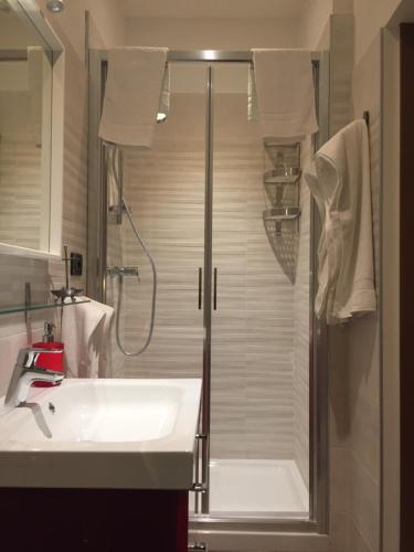 a bathroom with a shower and a white sink at B&B Garda 4U in Desenzano del Garda