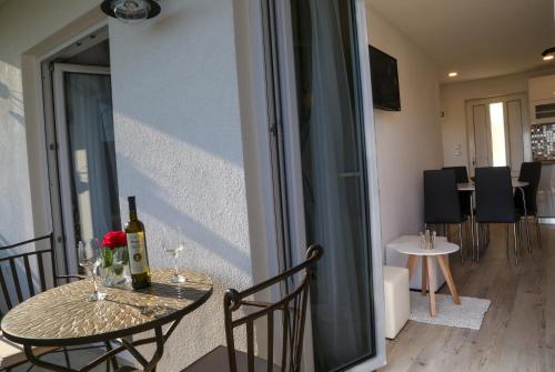 a table with two bottles of wine and a glass at Apartments Sunset in Hvar