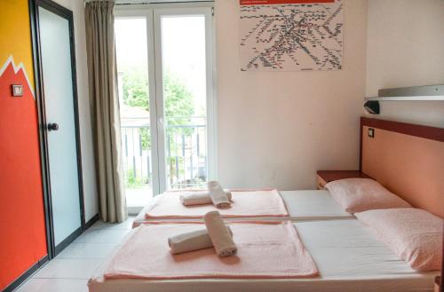 a room with two beds with towels on them at Hotel Elba in Rimini