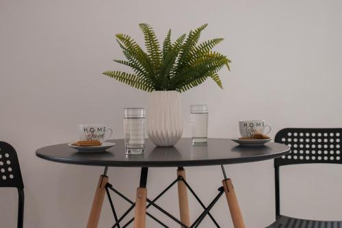 a table with a plant in a vase on it at Letta's Apartments in Finikas