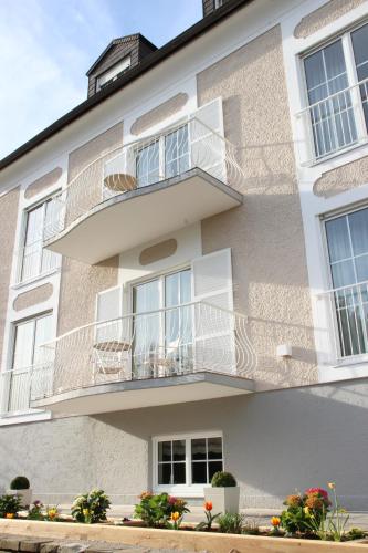 an apartment building with balconies and flowers at The Little Guesthouse in Salzburg
