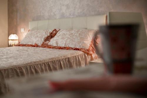 a bedroom with a bed and a cup on a table at La Casa di Pimpi in Desenzano del Garda