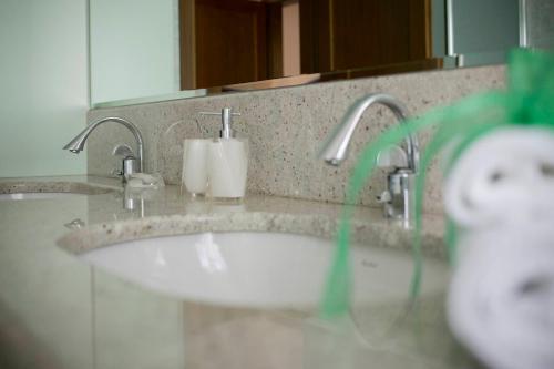 a bathroom sink with two faucets and a mirror at La Casa di Pimpi in Desenzano del Garda