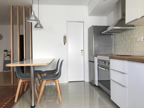 a kitchen with a table and two chairs and a table at Fátima4You in Fátima