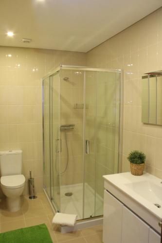 a bathroom with a shower and a toilet and a sink at Fátima4You in Fátima