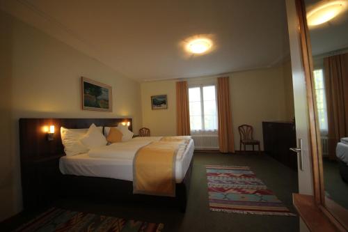 a hotel room with a bed and a window at Gasthaus zum Kreuz in Luzern