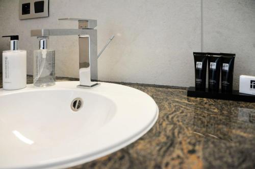 a bathroom sink with a faucet on a counter at Notarishuis Beveren B&B in Beveren
