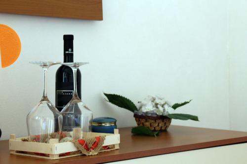 a table with two bottles of wine and a wine glass at Flamingo Room in Castellammare del Golfo