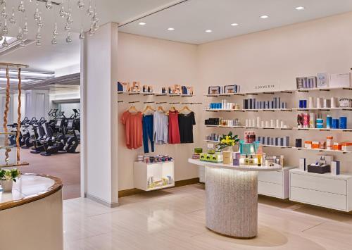 a dressing room with a store with clothes on shelves at Hotel Crescent Court in Dallas