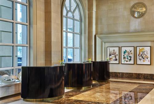 a row of chairs in a room with windows at Hotel Crescent Court in Dallas
