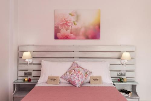 a bedroom with a bed with two pillows on it at Letta's Apartments in Finikas