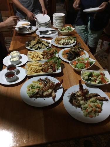 a long table with plates of food on it at Hotel Oasis Port Barton in San Vicente