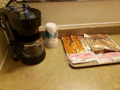a coffee maker sitting next to a pile of food at Cody Legacy Inn & Suites in Cody