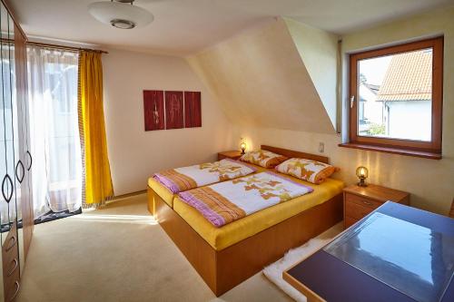 a bedroom with a bed and a flat screen tv at BodenSEE Apartment Friedrichshafen SEENAH in Friedrichshafen