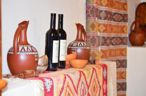 three bottles of wine sitting on top of a table at Family Hotel Lago & Wine Cellar in Lagodekhi