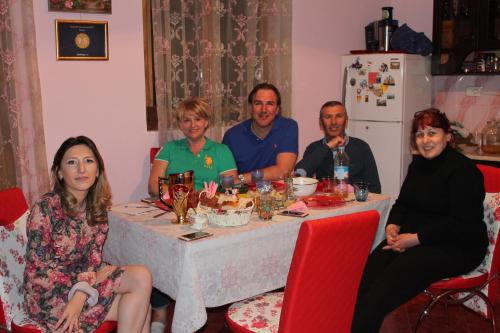 a large group of people sitting around a dinner table at Guesthouse Medea on Pushkini 4 in Kutaisi