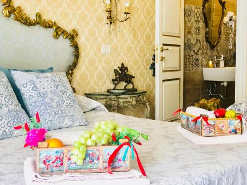 a bed with two baskets of fruit on it at Dimora Umberto in Catania