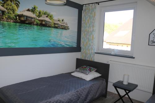 a bedroom with a bed and a large window at Apartamenty Amalia in Szary Dwor