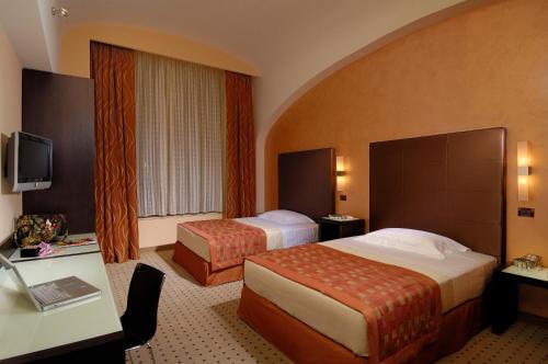 Posteľ alebo postele v izbe v ubytovaní Hotel La Cartiera