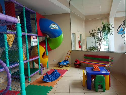a room with a play area with toys and a playground at Água Viva Hotel in Olímpia