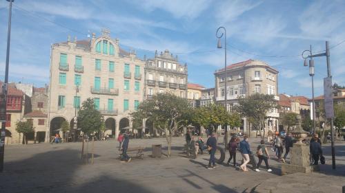a group of people standing around in a city at Apt Moderno céntrico y soleado in Pontevedra