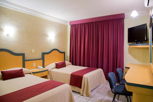 Cama o camas de una habitación en Hotel Madrid Minatitlán