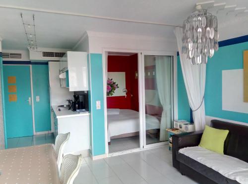 a room with a kitchen and a living room at Appartement Cap Hermès in Fréjus