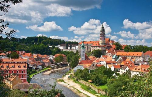 a view of a town with a river and buildings at Apartmán Šestka in Nová Pec