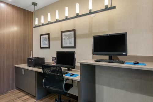an office with two computer monitors on a desk at Comfort Suites Fort Lauderdale Airport & Cruise Port in Dania Beach