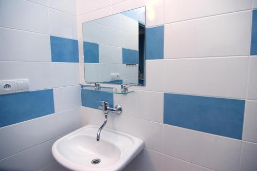 a bathroom with a sink and a mirror at Hotel Marttel in Karlovy Vary