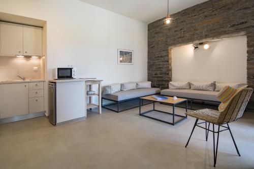 a living room with a couch and a table at Vourkari Village in Vourkarion