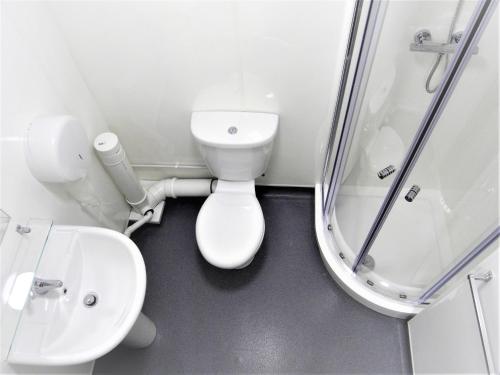 a bathroom with a toilet and a sink and a shower at The Stop - Hollies Truckstop Café in Cannock