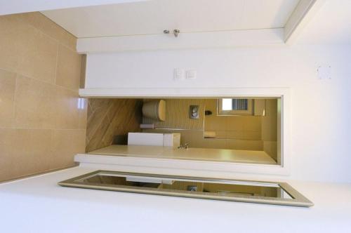 a kitchen with a sink and a mirror at Villa Martina in Ika